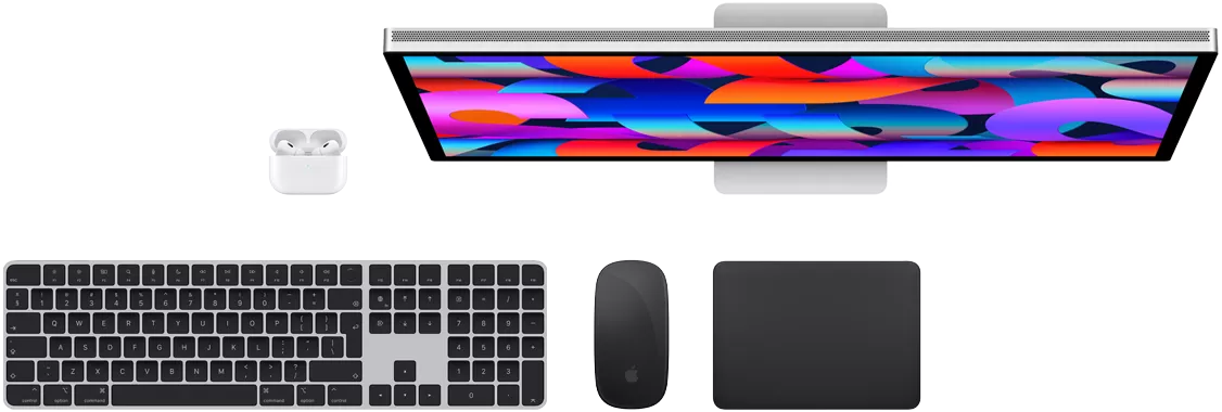 Mac aksesuarlarının yuxarıdan görünüşü: Studio Display, AirPods, Magic Keyboard, Magic Mouse və Magic Trackpad