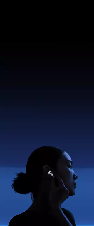 A person with their thumb and pointer finger holding the stem of their AirPods 5 to change listening modes