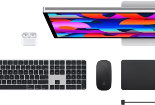 Top view of Mac accessories: Studio Display, AirPods, Magic Keyboard, Magic Mouse and Magic Trackpad