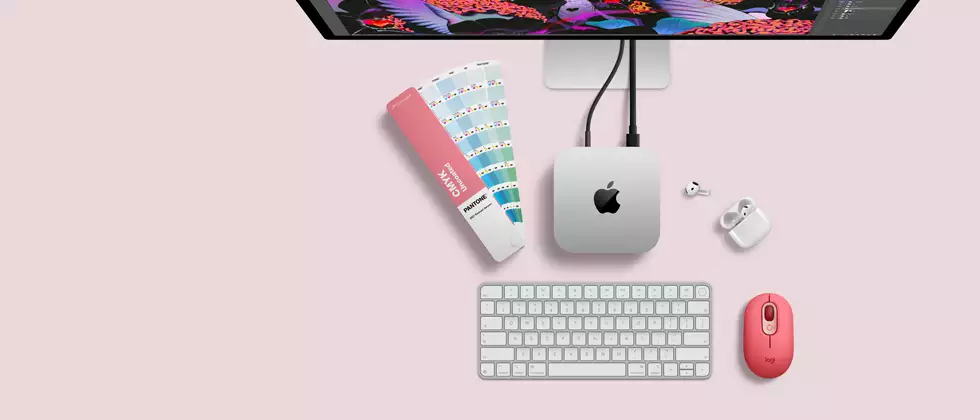 Mac mini, top, silver aluminum, rounded corners, glossy black Apple logo centered, connected by cord, Studio Display partially visible on top, AirPod 4, open, Pantone color swatches, and red Logitech keyboard and mouse