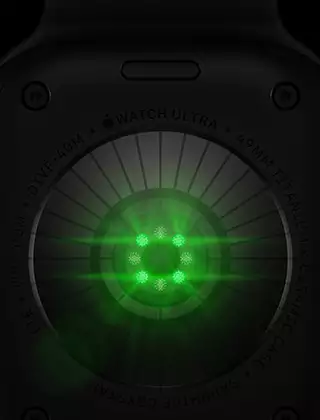 Back of Apple Watch Ultra 4, titanium case, black color, multiple round sensors with glowing green LED lights