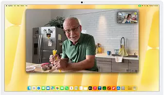 Desk View demonstration. Person on a video call watching top-down view of a baker decorating a cookie