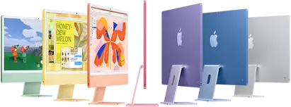 Seven iMac models in colors green, yellow, orange, pink, purple, blue, and silver, in an accordion arrangement