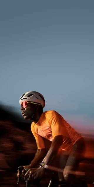 A picture of a person riding a bicycle wearing Apple Watch Series 9.