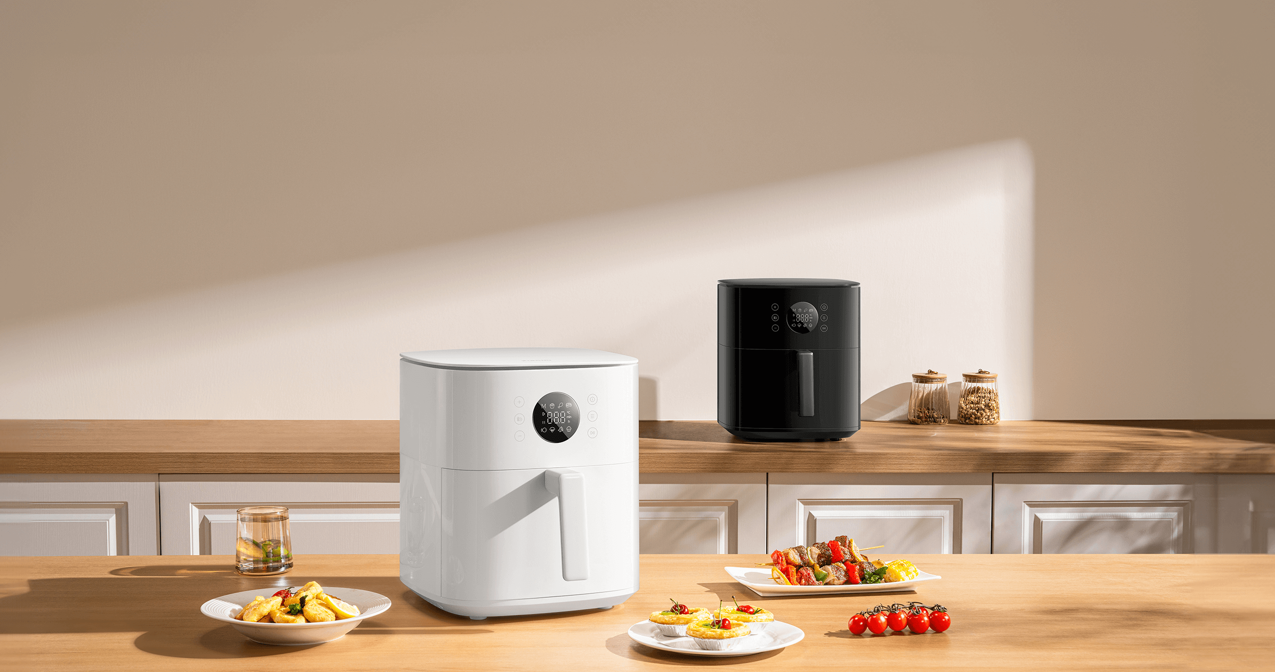 Аерофритюрник Xiaomi Air Fryer 6.5L в бяло и черно върху кухненски плот с приготвени ястия