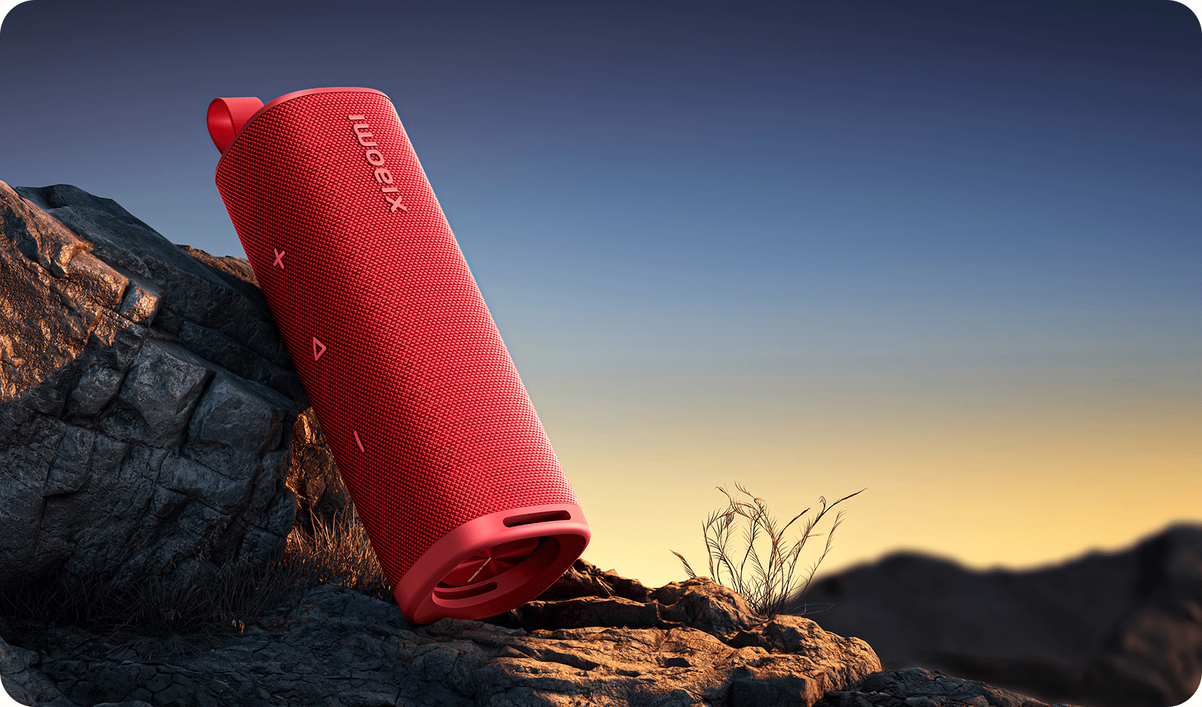 Xiaomi Sound Outdoor 30W в червено върху скала на залез
