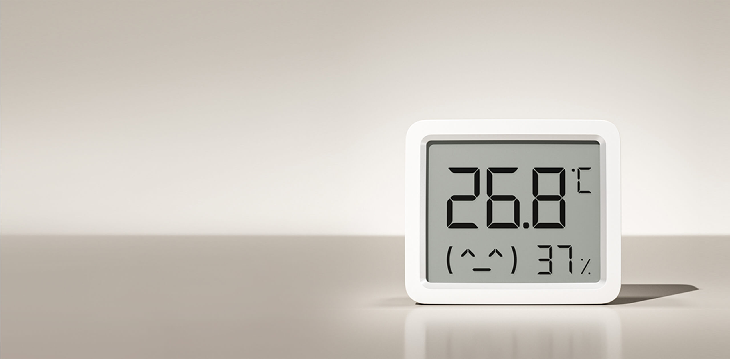 Едър план на екрана на Xiaomi Smart Temperature and Humidity Monitor 3 Mini с усмихнато личице