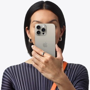 Person holding iPhone 15 Pro Max in front of their face